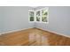 Bright bedroom features hardwood floors, neutral walls, and natural light from updated windows at 1521 N Duke St, Durham, NC 27701