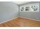 Bright bedroom featuring hardwood floors, neutral paint, and large windows at 1521 N Duke St, Durham, NC 27701