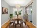 Charming dining room featuring a wooden table, modern lighting, and adjacent breakfast bar at 1521 N Duke St, Durham, NC 27701