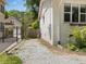 A gravel driveway alongside a white brick home offers ample parking and convenient access to the property at 1521 N Duke St, Durham, NC 27701