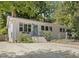 Charming white-painted brick home with a well-manicured yard and a quaint blue front door at 1521 N Duke St, Durham, NC 27701