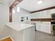 Modern kitchen features an island with quartz countertop, stainless steel appliances and eat in kitchen at 1521 N Duke St, Durham, NC 27701