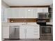 Bright kitchen with stainless steel appliances and white cabinets, complemented by modern countertops at 1521 N Duke St, Durham, NC 27701