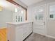 Kitchen island with ample storage, quartz countertop, door to back yard, and view of eating area at 1521 N Duke St, Durham, NC 27701