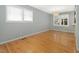 Bright living area with hardwood floors, two windows and neutral paint at 1521 N Duke St, Durham, NC 27701
