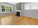Open living room with hardwood floors and a fireplace at 1521 N Duke St, Durham, NC 27701
