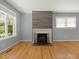 Bright living room with hardwood floors and a painted fireplace at 1521 N Duke St, Durham, NC 27701