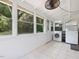 Bright sunroom with tile floor, laundry, ceiling fan and lots of natural light at 1521 N Duke St, Durham, NC 27701