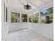 Inviting sunroom with tile floor, white trim, and windows providing outdoor views at 1521 N Duke St, Durham, NC 27701