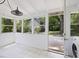 Bright sunroom featuring tile flooring, an outdoor view, and backyard access at 1521 N Duke St, Durham, NC 27701