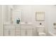Elegant bathroom with double vanity, white cabinets, and modern fixtures at 1581 Goldfinch Perch Ln, Knightdale, NC 27545