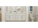 Bathroom featuring double sinks, white cabinetry, and a separate toilet area at 1581 Goldfinch Perch Ln, Knightdale, NC 27545