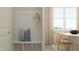Entryway with bench and coat rack leads into the bright dining room at 1581 Goldfinch Perch Ln, Knightdale, NC 27545