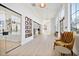 Long hallway with natural light, hardwood floors and comfortable seating at 1581 Goldfinch Perch Ln, Knightdale, NC 27545