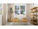 Well-lit home office featuring a modern desk, shelving, and large windows at 1581 Goldfinch Perch Ln, Knightdale, NC 27545