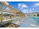 Community pool featuring lounge chairs and a covered pergola area for relaxing on sunny days at 1581 Goldfinch Perch Ln, Knightdale, NC 27545