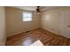 Bedroom features hardwood floors, a ceiling fan, and natural light from a window at 167 Chic Ennis Rd, Coats, NC 27521