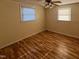 Bedroom featuring hardwood floors and natural light from two windows at 167 Chic Ennis Rd, Coats, NC 27521