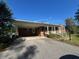 Charming brick house with a covered carport and a driveway leading to the entrance at 167 Chic Ennis Rd, Coats, NC 27521
