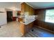 View of kitchen featuring wood cabinets, appliances, and a bar counter separating the living space at 167 Chic Ennis Rd, Coats, NC 27521