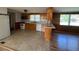 Kitchen and dining area features wooden cabinets, tiled flooring, and wood paneling at 167 Chic Ennis Rd, Coats, NC 27521
