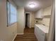 Laundry room with a window, white cabinets and a chest freezer at 167 Chic Ennis Rd, Coats, NC 27521