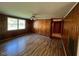 Living room featuring knotty pine paneling and a ceiling fan at 167 Chic Ennis Rd, Coats, NC 27521
