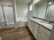 A bright bathroom with a separate shower and tub, and a dual sink vanity with a granite countertop at 167 Lotus Ave, Smithfield, NC 27577