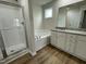 A bright bathroom with a separate shower and tub, and a vanity with a granite countertop at 167 Lotus Ave, Smithfield, NC 27577