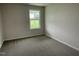 Comfortable carpeted bedroom with natural light from a window overlooking the backyard at 167 Lotus Ave, Smithfield, NC 27577