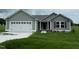 Charming single-Gathering home with gray siding, a two-car garage, and a well-maintained lawn at 167 Lotus Ave, Smithfield, NC 27577