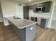 A bright kitchen features gray cabinets, granite countertops, and modern finishes at 167 Lotus Ave, Smithfield, NC 27577