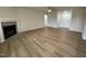 Spacious living room with vinyl flooring, a fireplace, and a ceiling fan for added comfort at 167 Lotus Ave, Smithfield, NC 27577