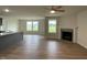Open concept living area featuring luxury vinyl flooring, a fireplace, and natural light at 167 Lotus Ave, Smithfield, NC 27577