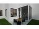 Relaxing back patio with outdoor seating and a view into the sunroom at 1800 Pershing Rd, Raleigh, NC 27608