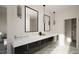Modern bathroom with double vanity, sleek black cabinets, stylish lighting, and marble flooring at 1800 Pershing Rd, Raleigh, NC 27608