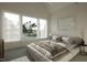 Bright bedroom featuring a large window with scenic views, a plush bed, and modern decor at 1800 Pershing Rd, Raleigh, NC 27608