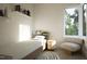 Serene bedroom featuring a single bed, shelving, and a comfortable accent chair at 1800 Pershing Rd, Raleigh, NC 27608