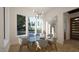 Bright dining room with a modern chandelier and large windows overlooking the greenery at 1800 Pershing Rd, Raleigh, NC 27608