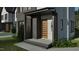 Chic home entrance boasting a stylish front door, stone accents, and manicured landscaping at 1800 Pershing Rd, Raleigh, NC 27608