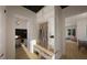 Hallway features bench with storage, closet, and views into the study and living room at 1800 Pershing Rd, Raleigh, NC 27608