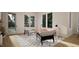 Bright living room featuring stylish furniture, large windows, and a modern geometric rug at 1800 Pershing Rd, Raleigh, NC 27608