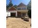 New construction home featuring a two-car garage, covered front porch, and wood and light-green siding at 188 Landon Ridge, Sanford, NC 27330
