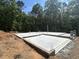 Image of newly poured foundation ready for framing, surrounded by lush trees at 188 Landon Ridge, Sanford, NC 27330