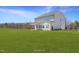 Expansive backyard featuring a covered patio, perfect for outdoor entertaining and relaxation at 1931 Ballard Rd, Fuquay Varina, NC 27526