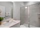 Well-lit bathroom with single sink vanity, quartz countertop, glass-enclosed shower with built-in niche at 1931 Ballard Rd, Fuquay Varina, NC 27526