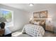 This bedroom features neutral walls, comfy carpet, and bright light from a large window at 1931 Ballard Rd, Fuquay Varina, NC 27526