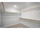 Walk-in closet with ample storage space, featuring built-in shelving and rods for organized clothing at 1931 Ballard Rd, Fuquay Varina, NC 27526
