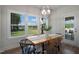 Bright dining room with a wooden table, decorative light fixture, and large windows with views at 1931 Ballard Rd, Fuquay Varina, NC 27526