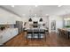 Spacious kitchen with a large island, stainless steel appliances, light countertops and pendant lighting at 1931 Ballard Rd, Fuquay Varina, NC 27526